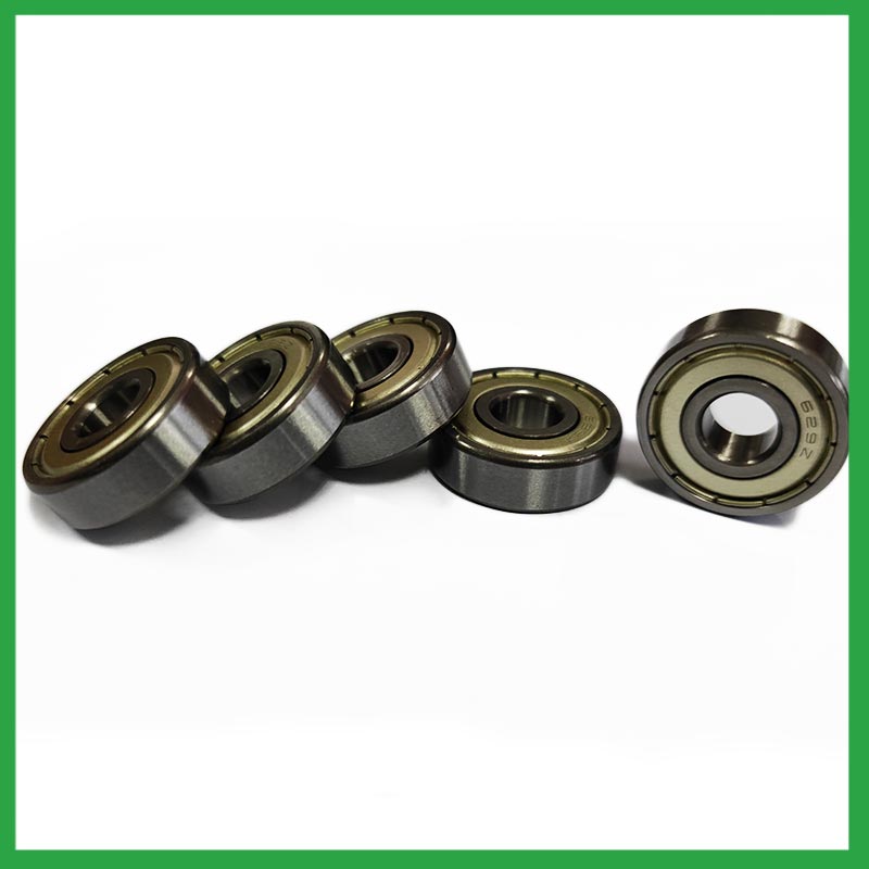 What is the role of ball bearings in reducing friction and energy loss in rotating machinery?